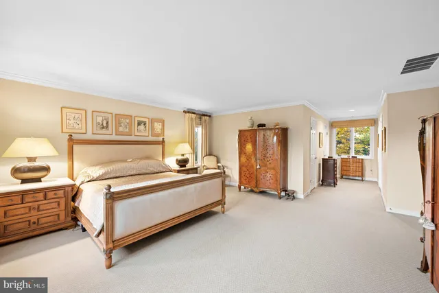 a spacious bedroom with a bed and cabinets