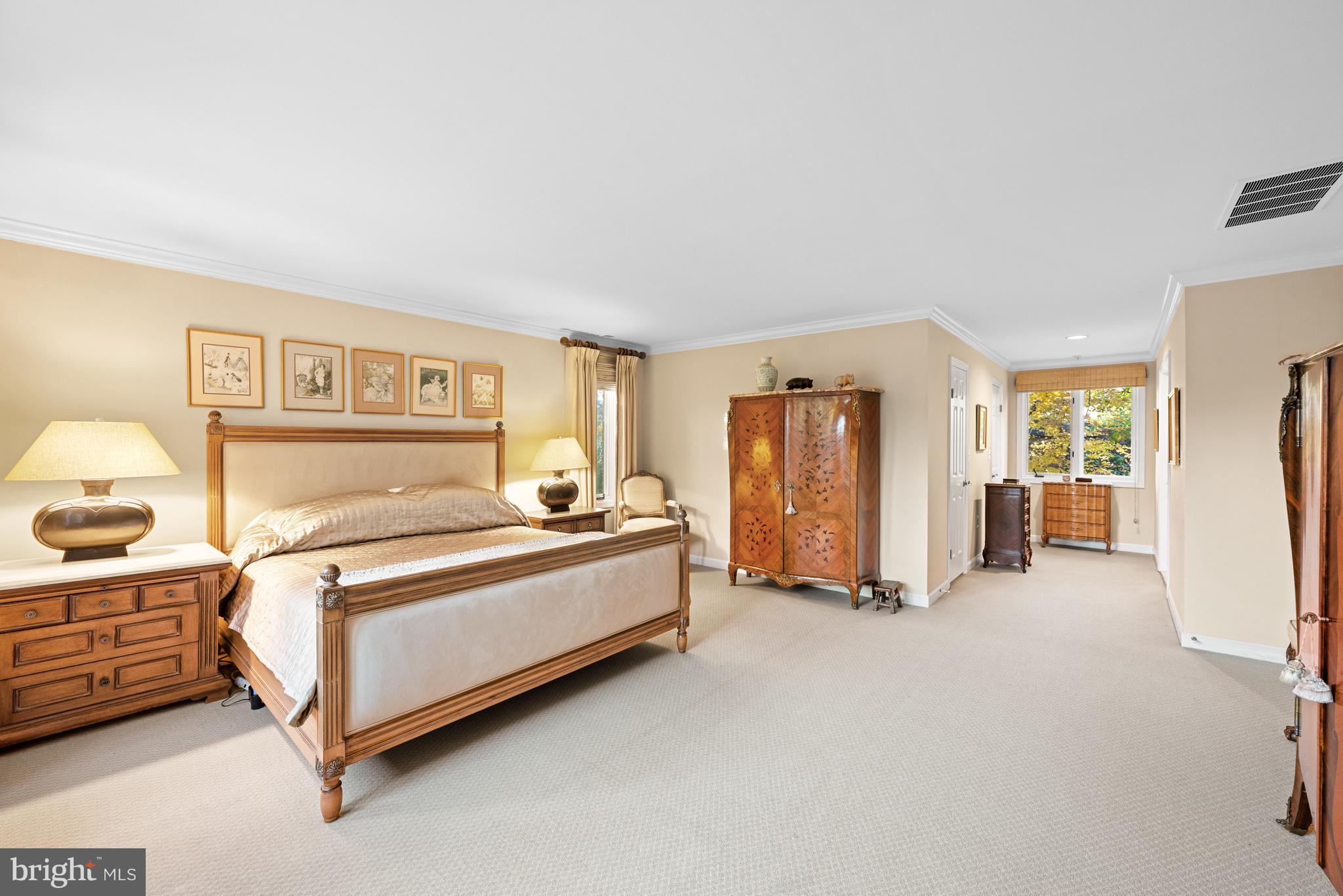 4616 Foxhall Crescent Northwest Washington, DC 20007 - Photo 11 of 21 a spacious bedroom with a bed and cabinets