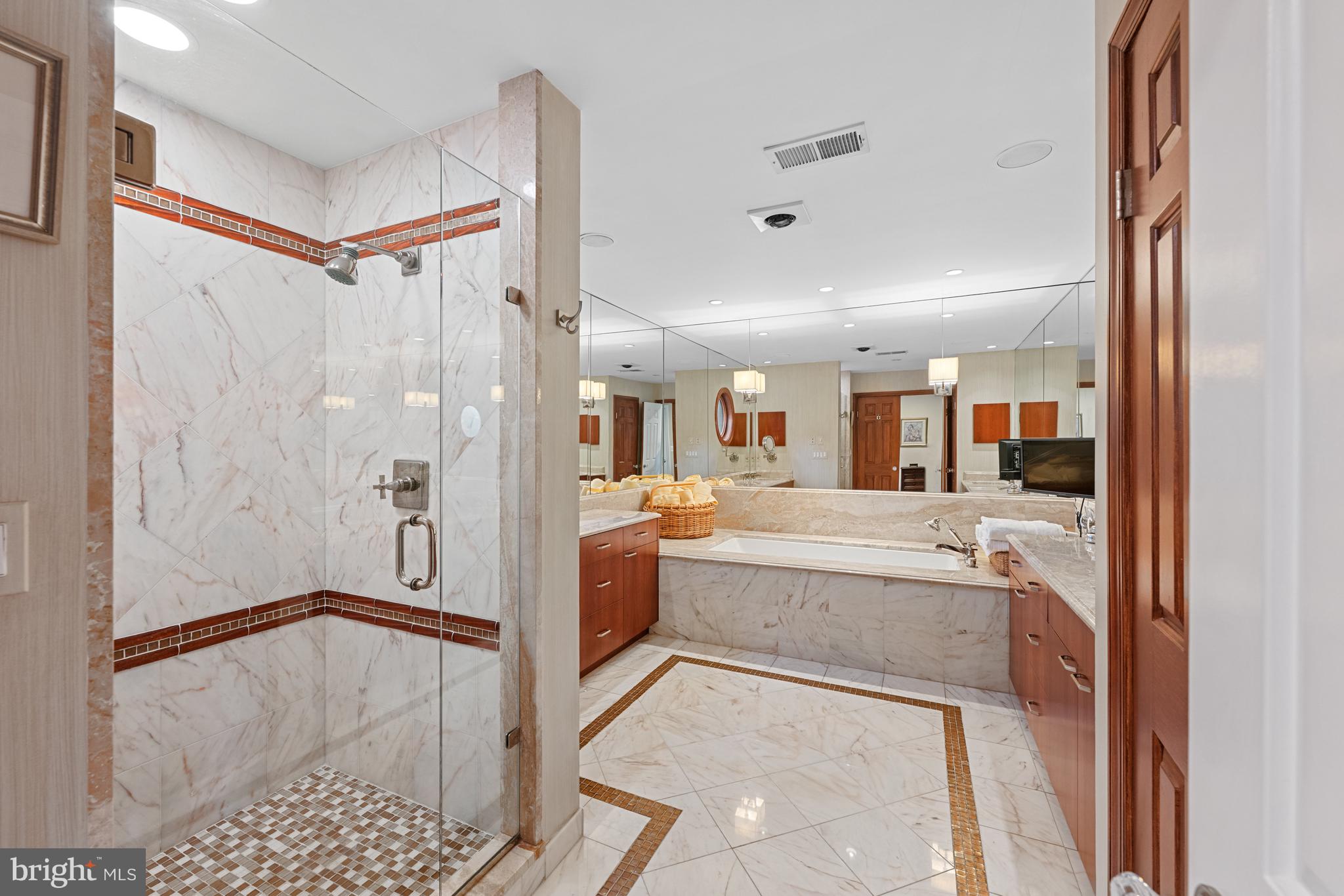 4616 Foxhall Crescent Northwest Washington, DC 20007 - Photo 12 of 21 a bathroom with a tub shower sink and mirror