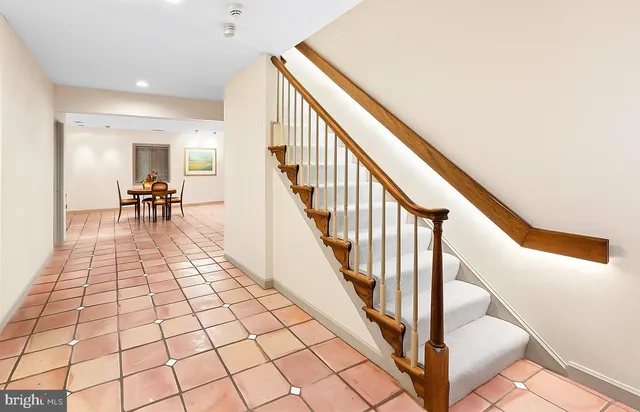 a view of an empty room and staircase