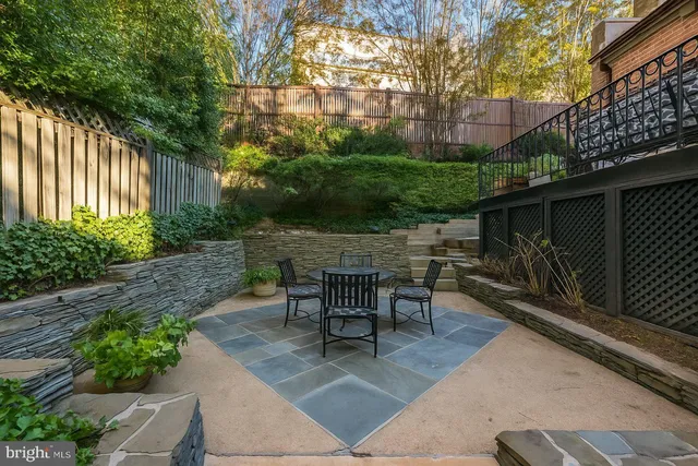 a view of a patio with table and chairs and potted plants