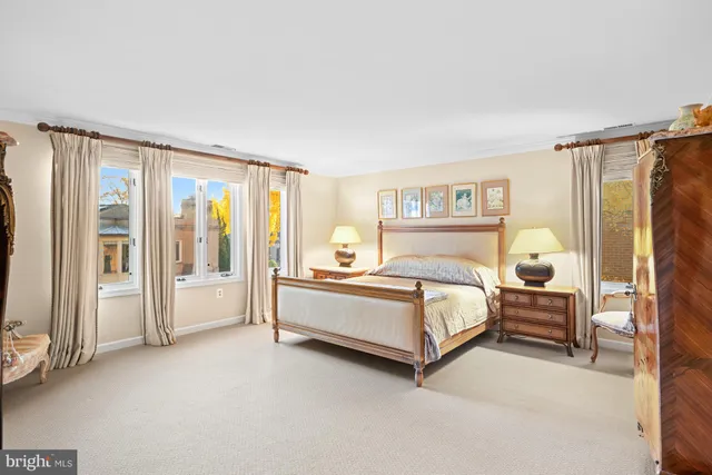 a spacious bedroom with a bed and a large window