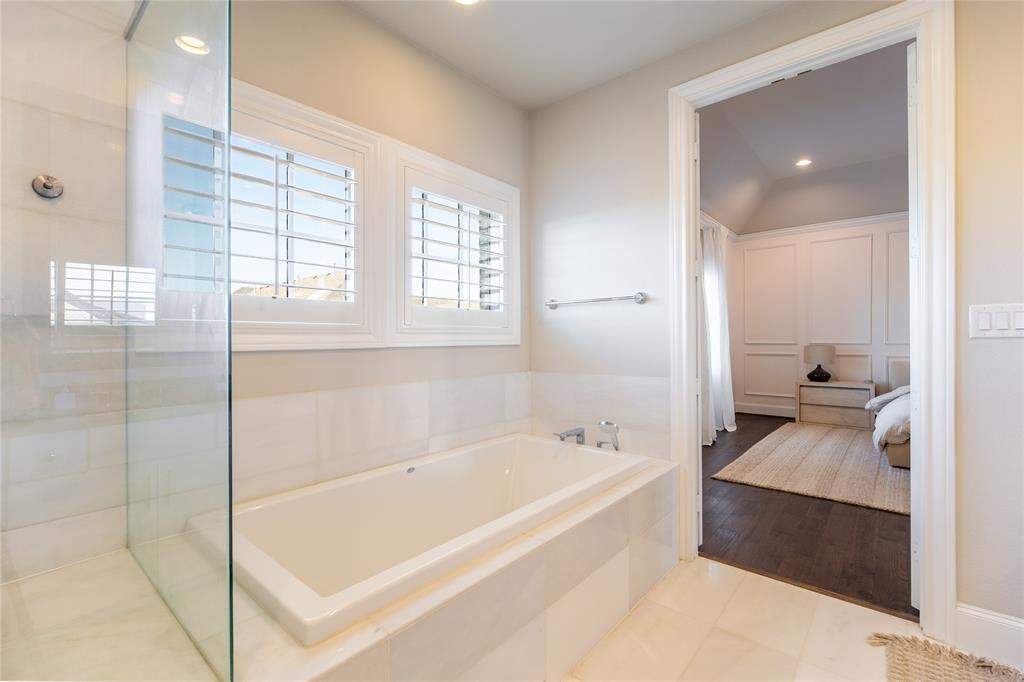 4116 Runyon Road Addison, TX 75001 - Photo 21 of 31 a spacious bathroom with a tub shower and sink