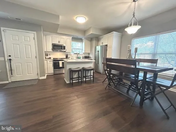 a kitchen with stainless steel appliances a stove a sink island and a refrigerator