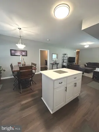 a dining room with furniture a chandelier and wooden floor