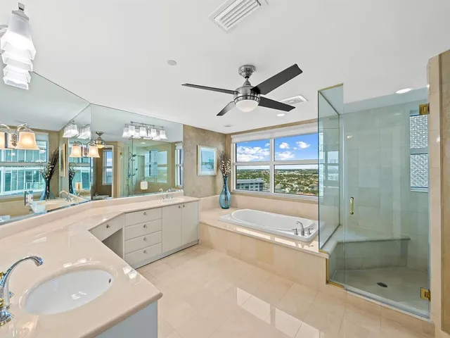 a large spacious bathroom with a large tub and shower