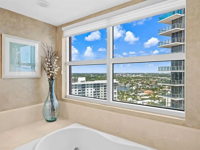 a bathroom with a tub and window