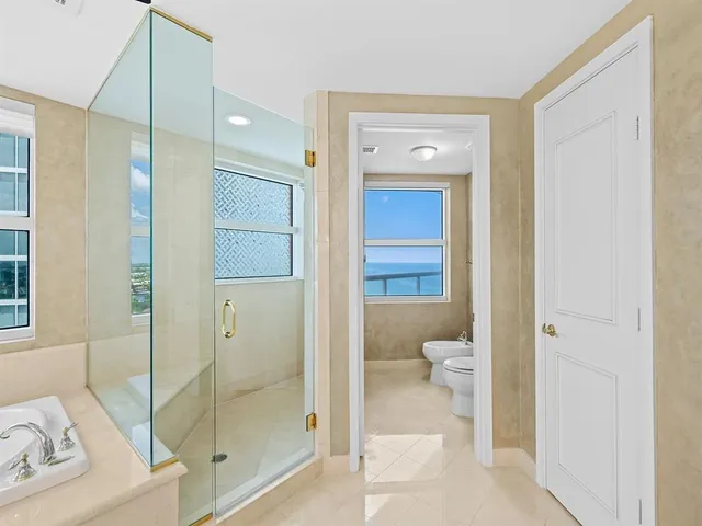 a bathroom with a granite countertop sink mirror and toilet
