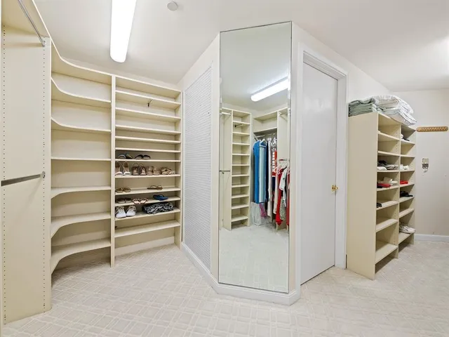 a view of walk in closet with white walls