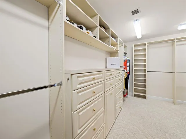a view of walk in closet with white walls