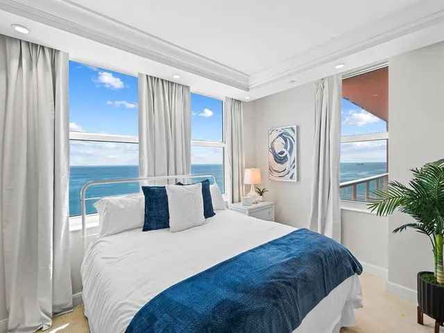 a bedroom with a large bed and a large window