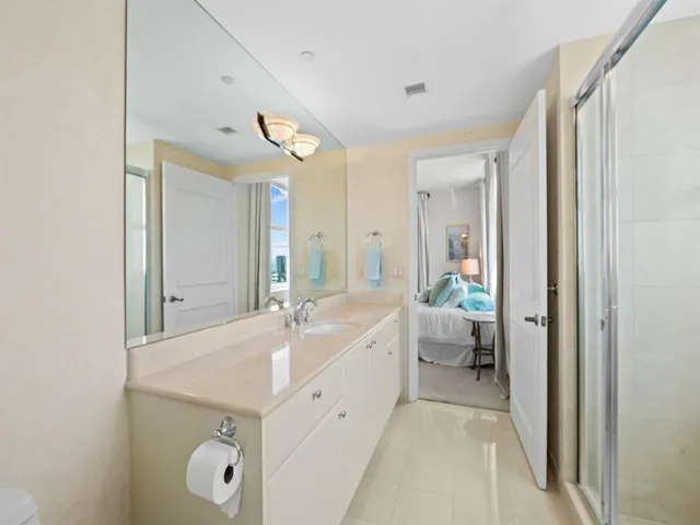 a spacious bathroom with a double vanity sink and a mirror