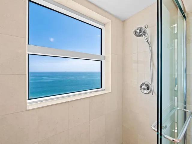 a bathroom with a shower and a mirror