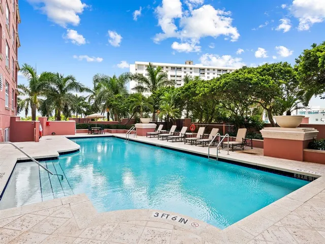 a view of a swimming pool with outdoor seating