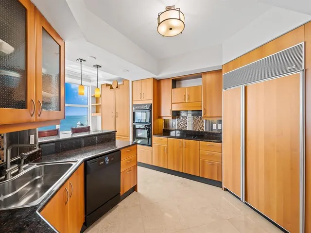 a kitchen with stainless steel appliances a sink and a large window