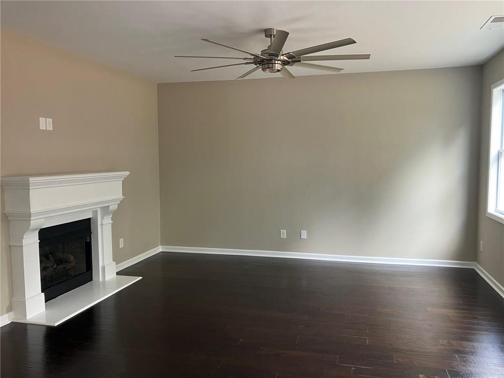 2808 Brookford Lane Southwest Atlanta, GA 30331 - Photo 5 of 25 a view of an empty room with wooden floor and a fireplace