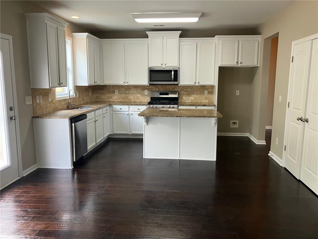 2808 Brookford Lane Southwest Atlanta, GA 30331 - Photo 6 of 25 a kitchen with granite countertop a refrigerator stove top oven and sink