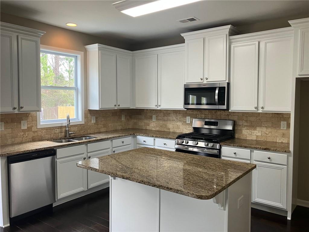 2808 Brookford Lane Southwest Atlanta, GA 30331 - Photo 7 of 25 a kitchen with granite countertop a sink stove and cabinets