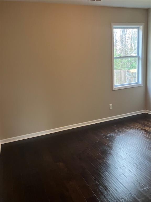 2808 Brookford Lane Southwest Atlanta, GA 30331 - Photo 8 of 25 an empty room with wooden floor and windows