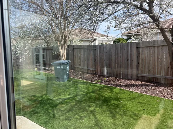 a backyard of a house with table and chairs