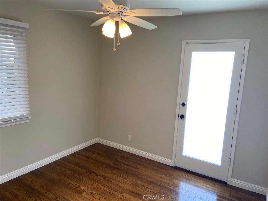 3603 148th Place Hawthorne, CA 90250 - Photo 13 of 19 an empty room with wooden floor chandelier fan and windows