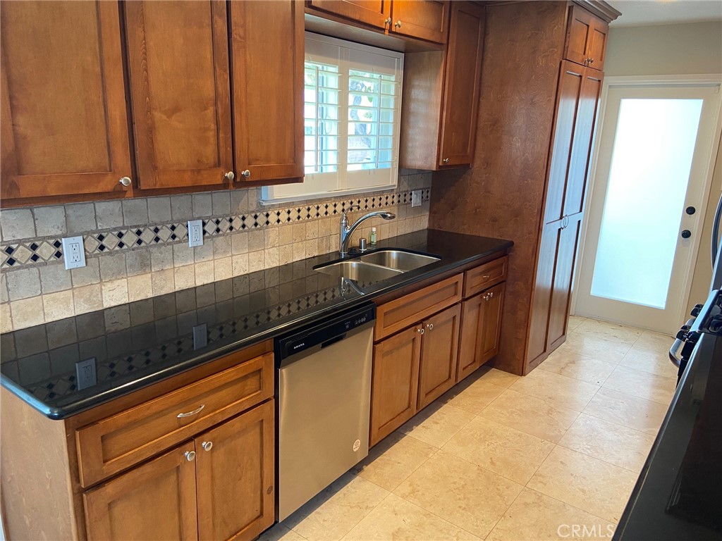 3603 148th Place Hawthorne, CA 90250 - Photo 5 of 19 a kitchen with granite countertop a sink and a stove