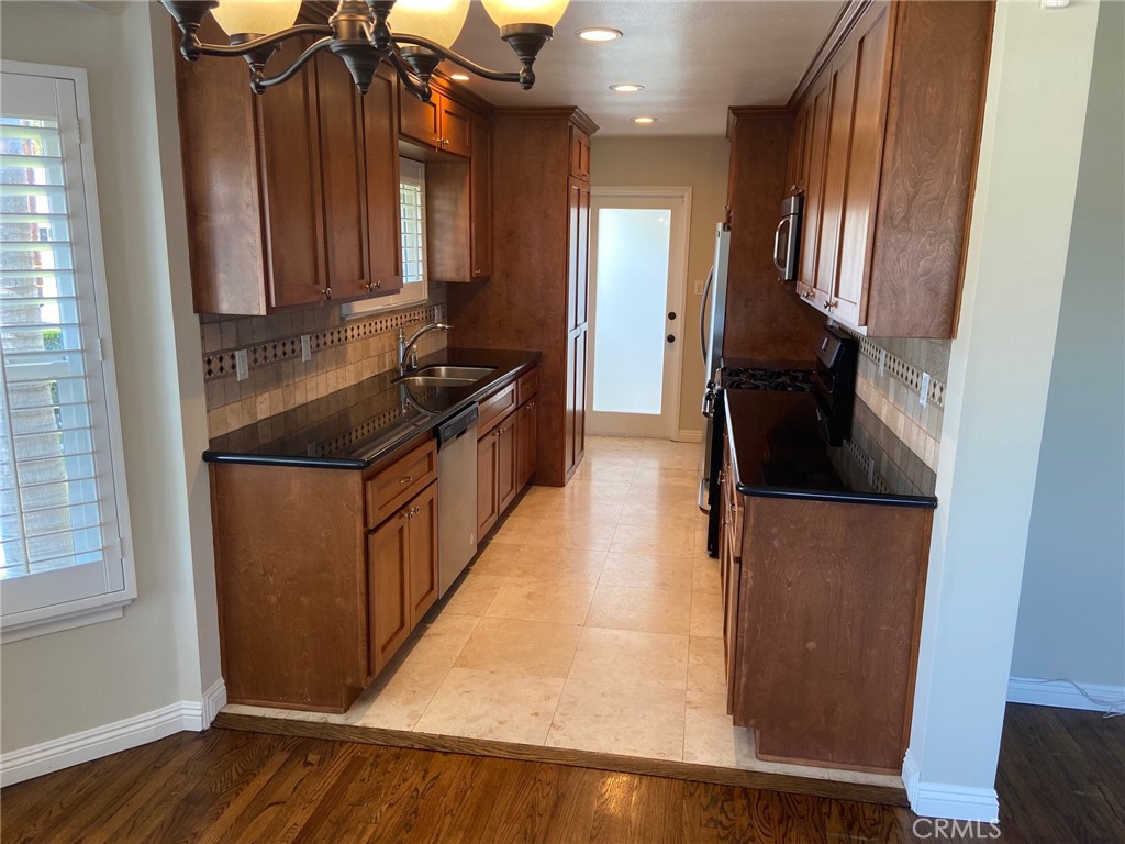3603 148th Place Hawthorne, CA 90250 - Photo 7 of 19 a kitchen with granite countertop a refrigerator and a stove