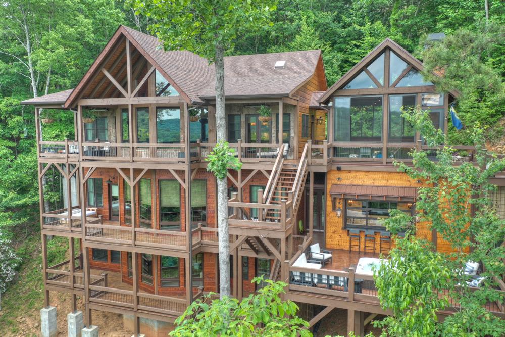 a view of a house with a yard and potted plants