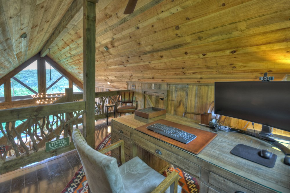 436 Geronimo Road Cherry Log, GA 30522 - Photo 37 of 72 a view of a balcony with chairs and wooden floor