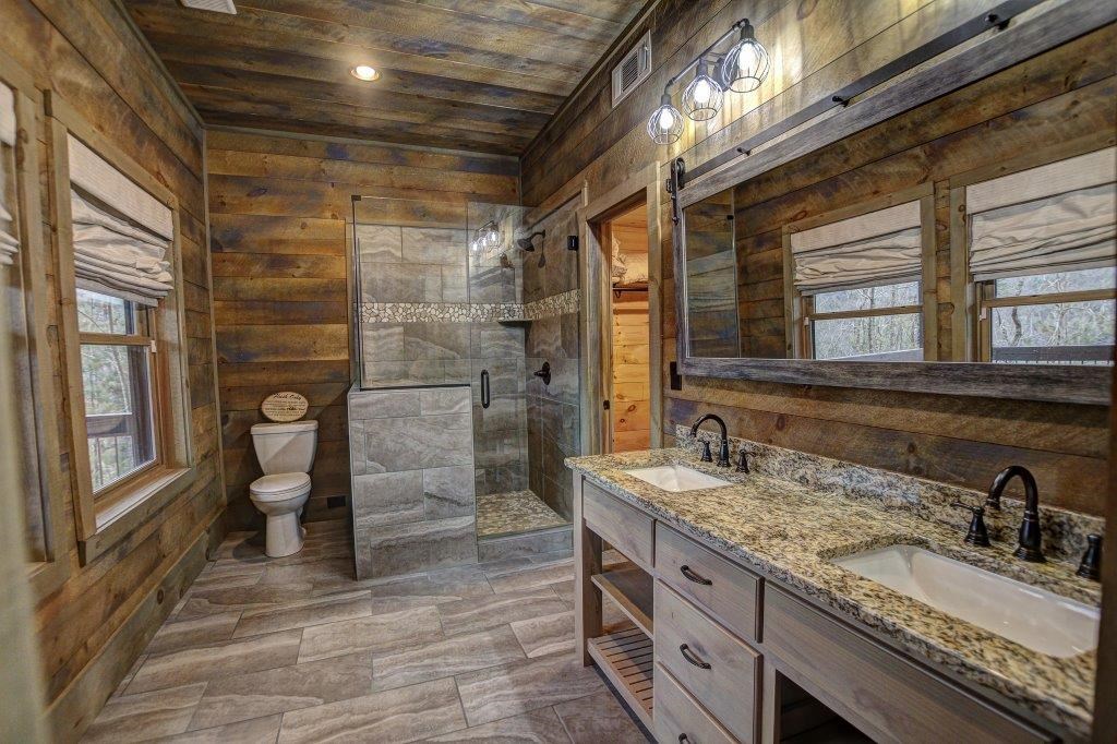 436 Geronimo Road Cherry Log, GA 30522 - Photo 54 of 72 a bathroom with a granite countertop sink a toilet and a shower