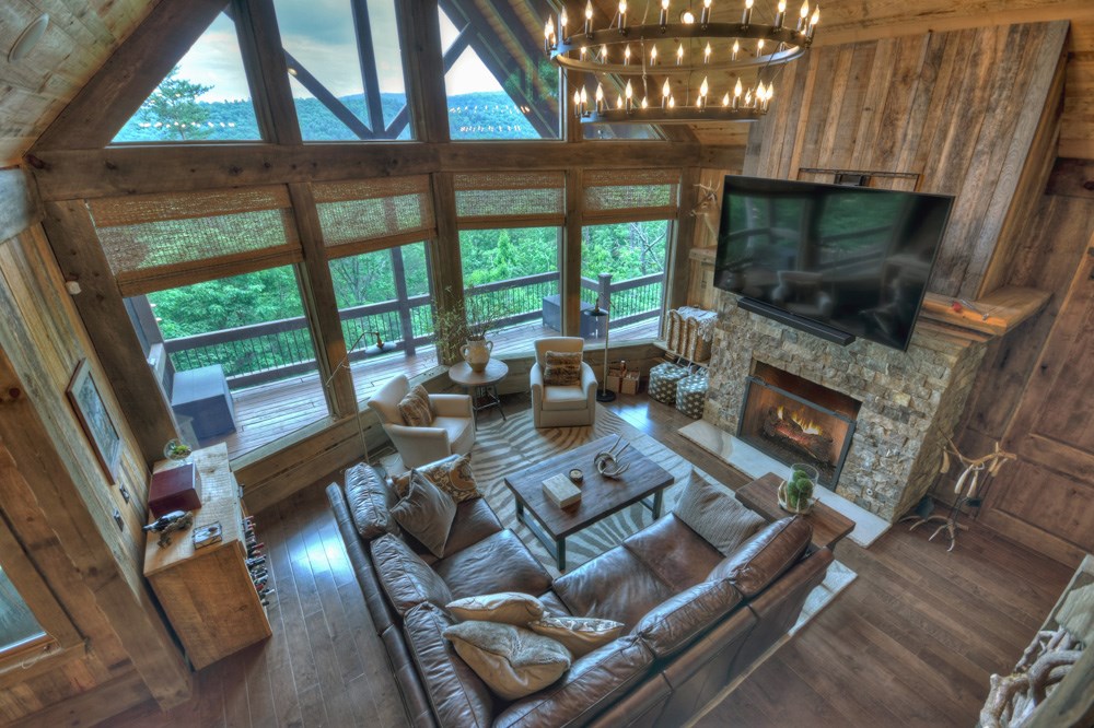 436 Geronimo Road Cherry Log, GA 30522 - Photo 7 of 72 a living room with furniture a flat screen tv and a floor to ceiling window
