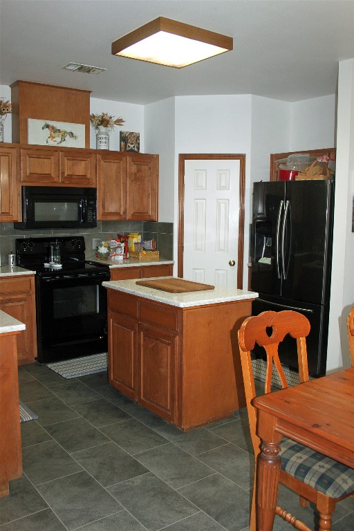 2542 Witter Road Lockhart, TX 78644 - Photo 19 of 40 a kitchen with stainless steel appliances granite countertop a stove top oven a sink a dining table and chairs