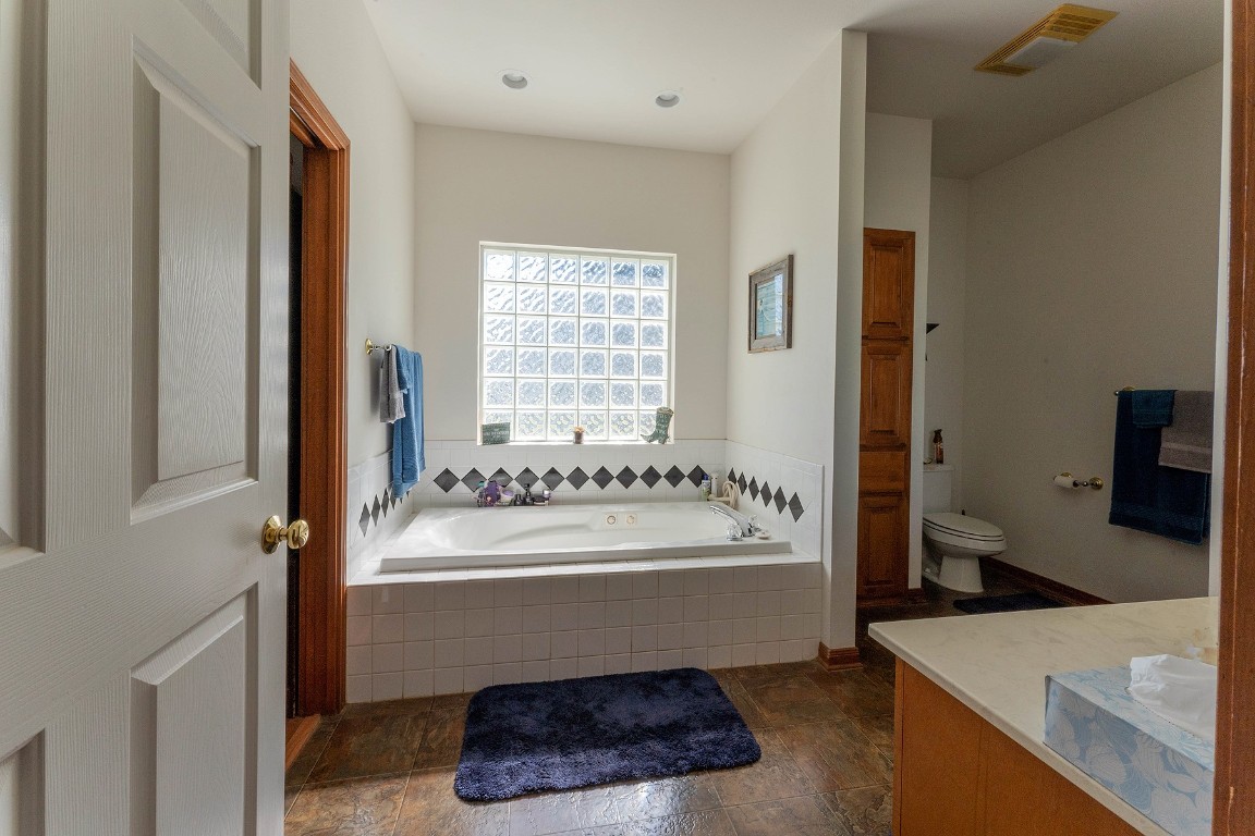 2542 Witter Road Lockhart, TX 78644 - Photo 37 of 40 a bathroom with a tub sink and mirror