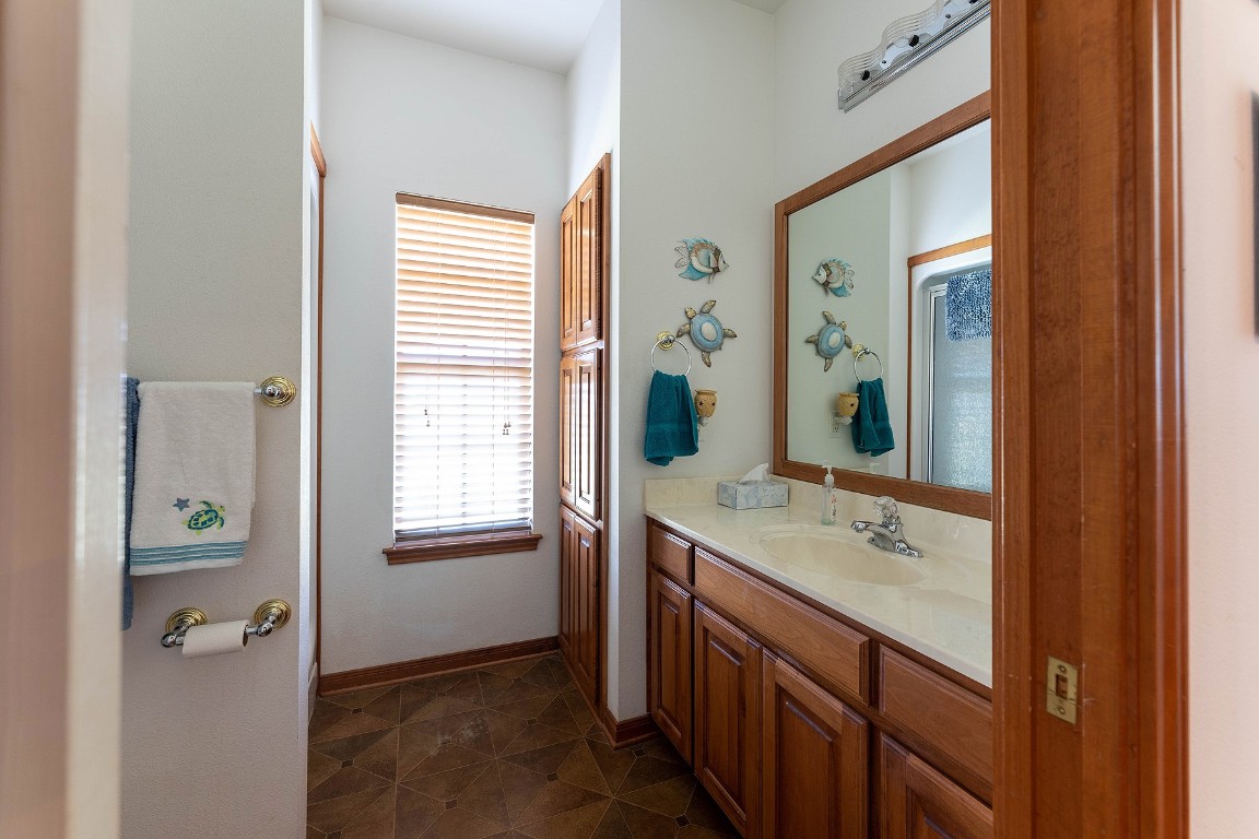 2542 Witter Road Lockhart, TX 78644 - Photo 40 of 40 a bathroom with a sink a mirror and a bathtub