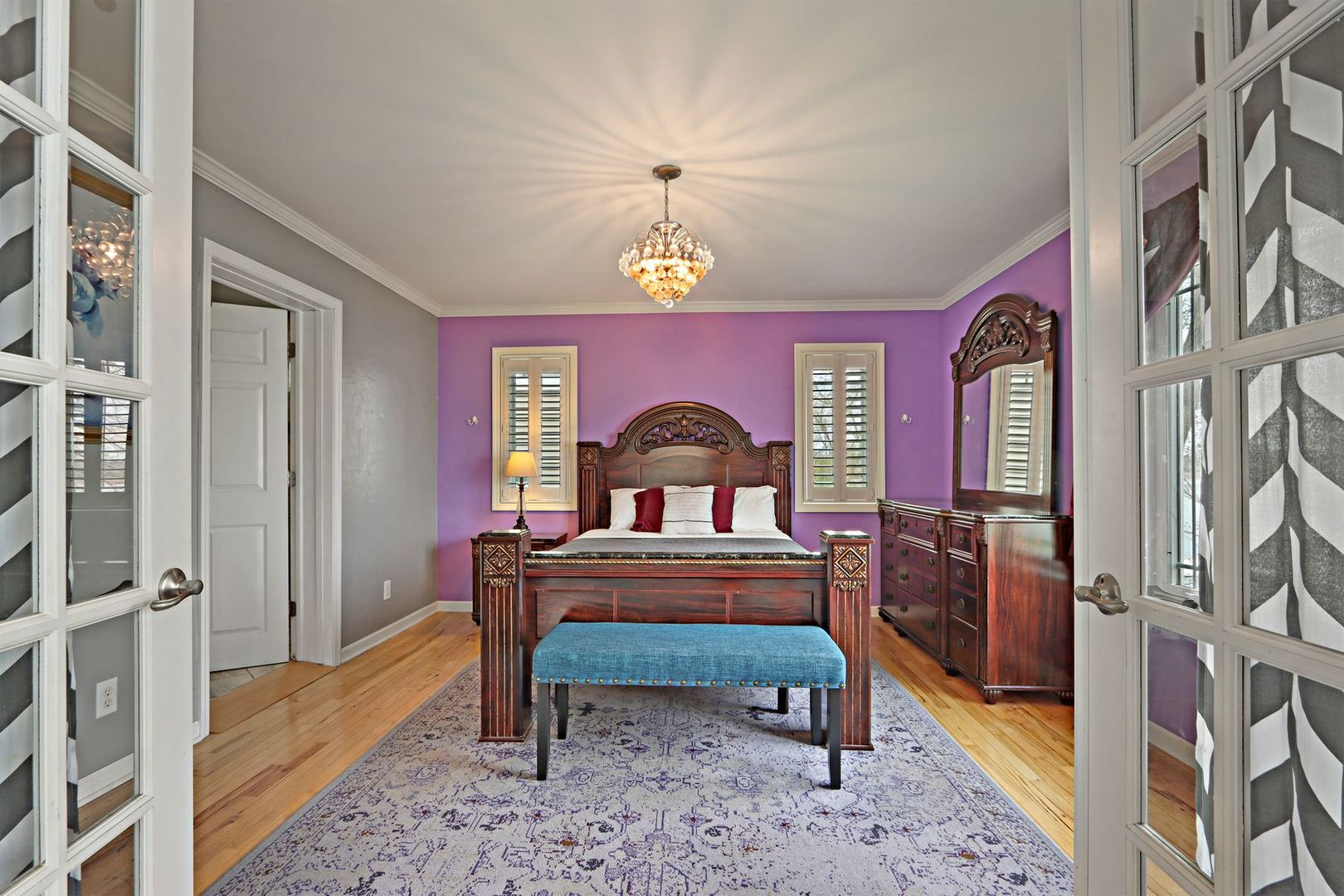 W4226 West End Road Lake Geneva, WI 53147 - Photo 15 of 44 a bedroom with a bed and a chandelier