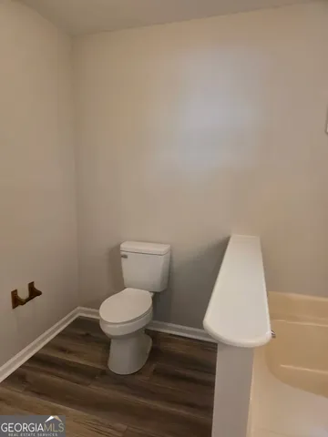 a white toilet sitting next to a white sink