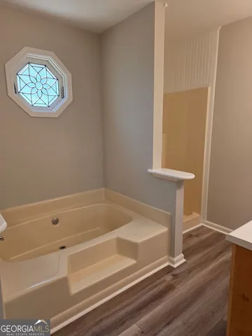 a bathroom with a tub and a shower