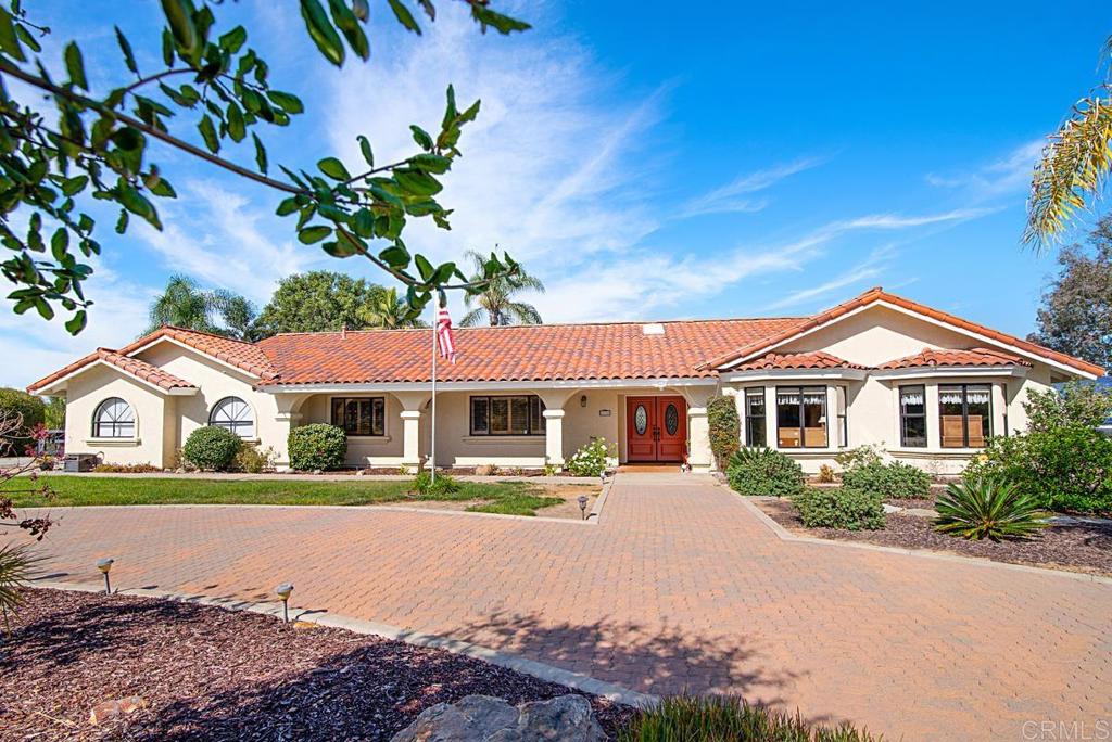 3374 Sol Vista Fallbrook, CA 92028 - Photo 1 of 1 a front view of a house with a yard and trees