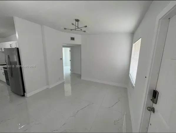 a bathroom with a bathtub sink mirror vanity and toilet