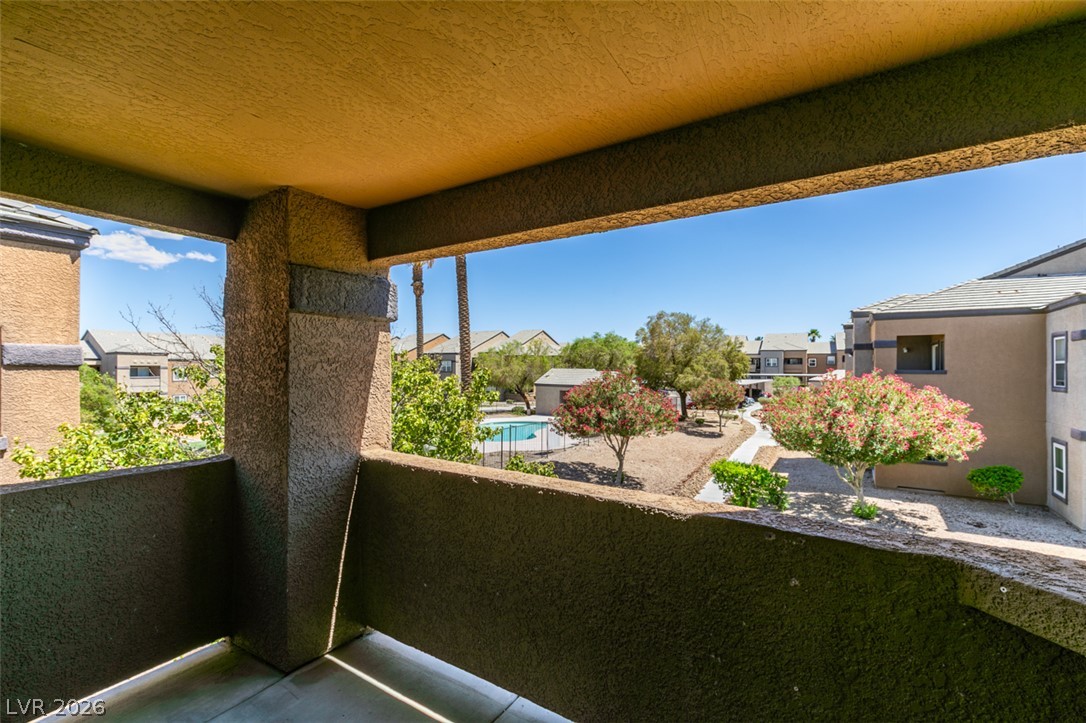 6650 West Warm Springs Road, Unit 2118 Las Vegas, NV 89118 - Photo 33 of 41 Enjoy tranquil views of the community pool and lush landscaping from this private balcony.