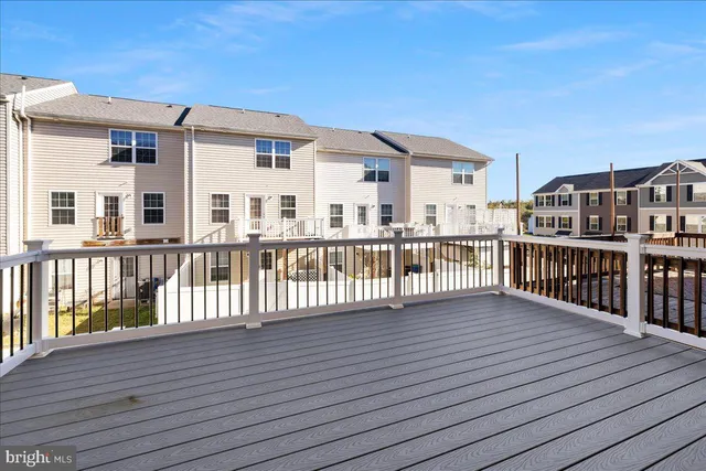 a kitchen with stainless steel appliances granite countertop wooden cabinets a refrigerator a sink a stove a microwave and wooden floors