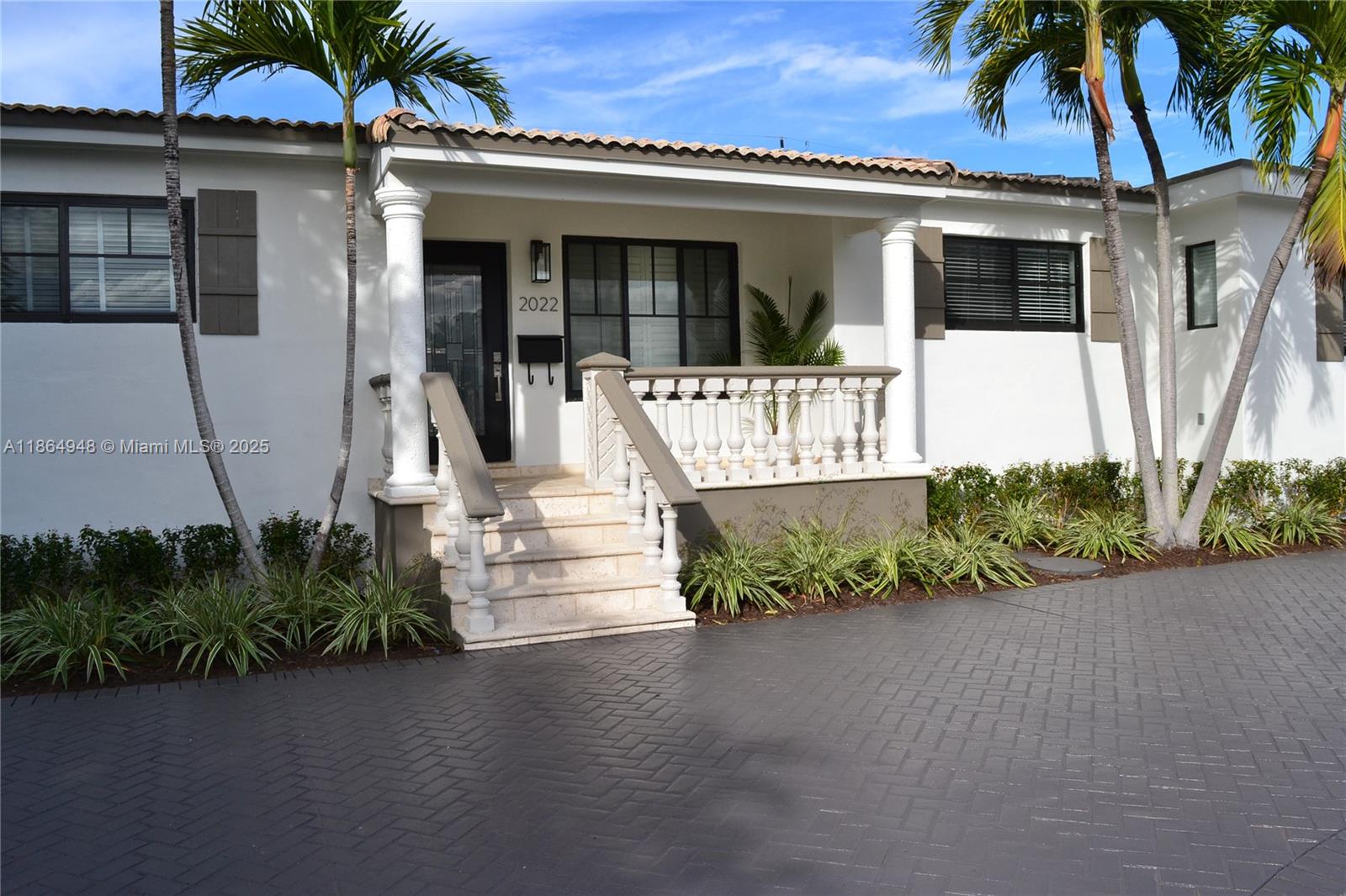 2022 Southwest 82nd Court, Unit B Miami, FL 33155 - Photo 1 of 15 a front view of a house with a garden