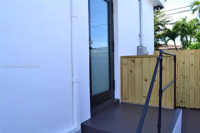 a bathroom with a granite countertop sink and a toilet