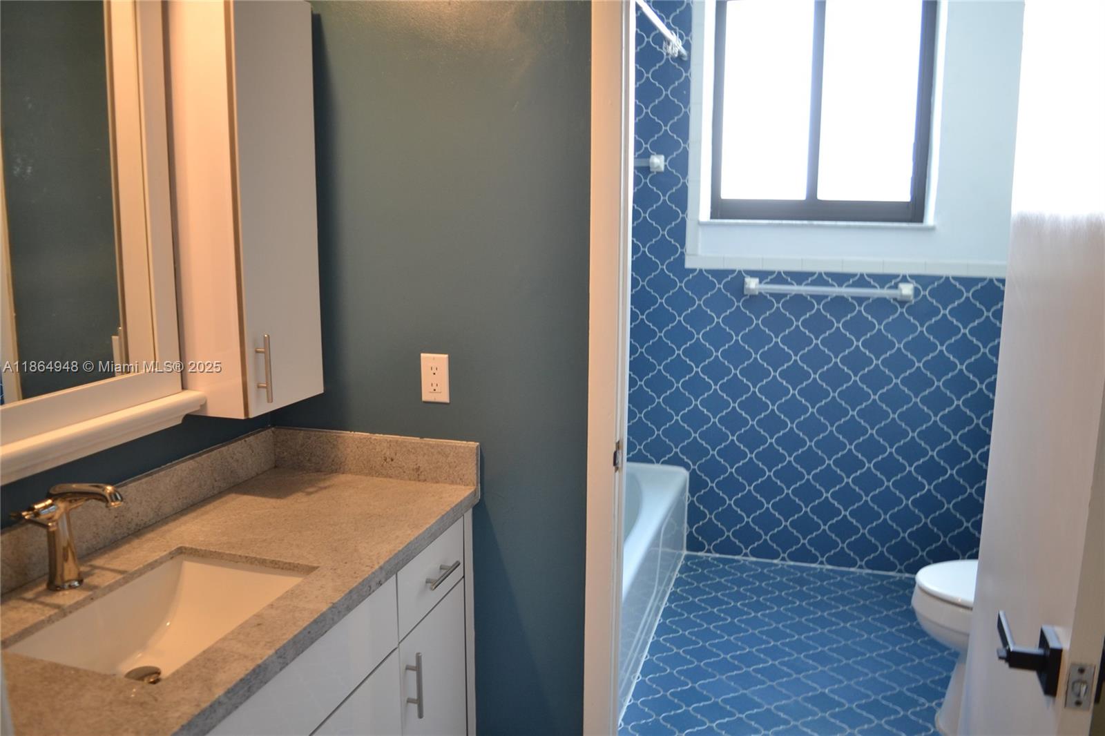 2022 Southwest 82nd Court, Unit B Miami, FL 33155 - Photo 15 of 15 a bathroom with a granite countertop sink and a toilet