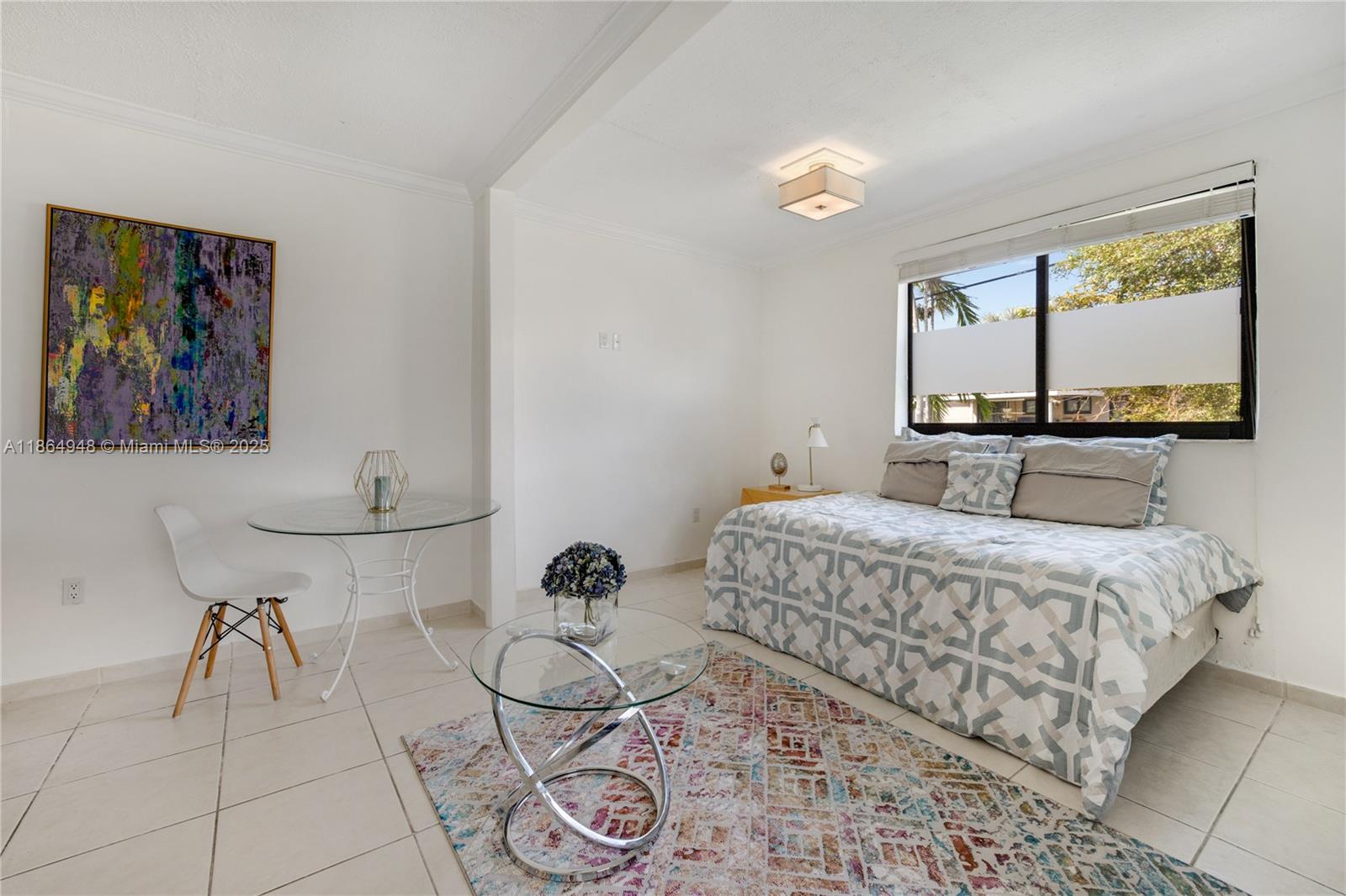 2022 Southwest 82nd Court, Unit B Miami, FL 33155 - Photo 3 of 15 a bedroom with a bed and painting on the wall