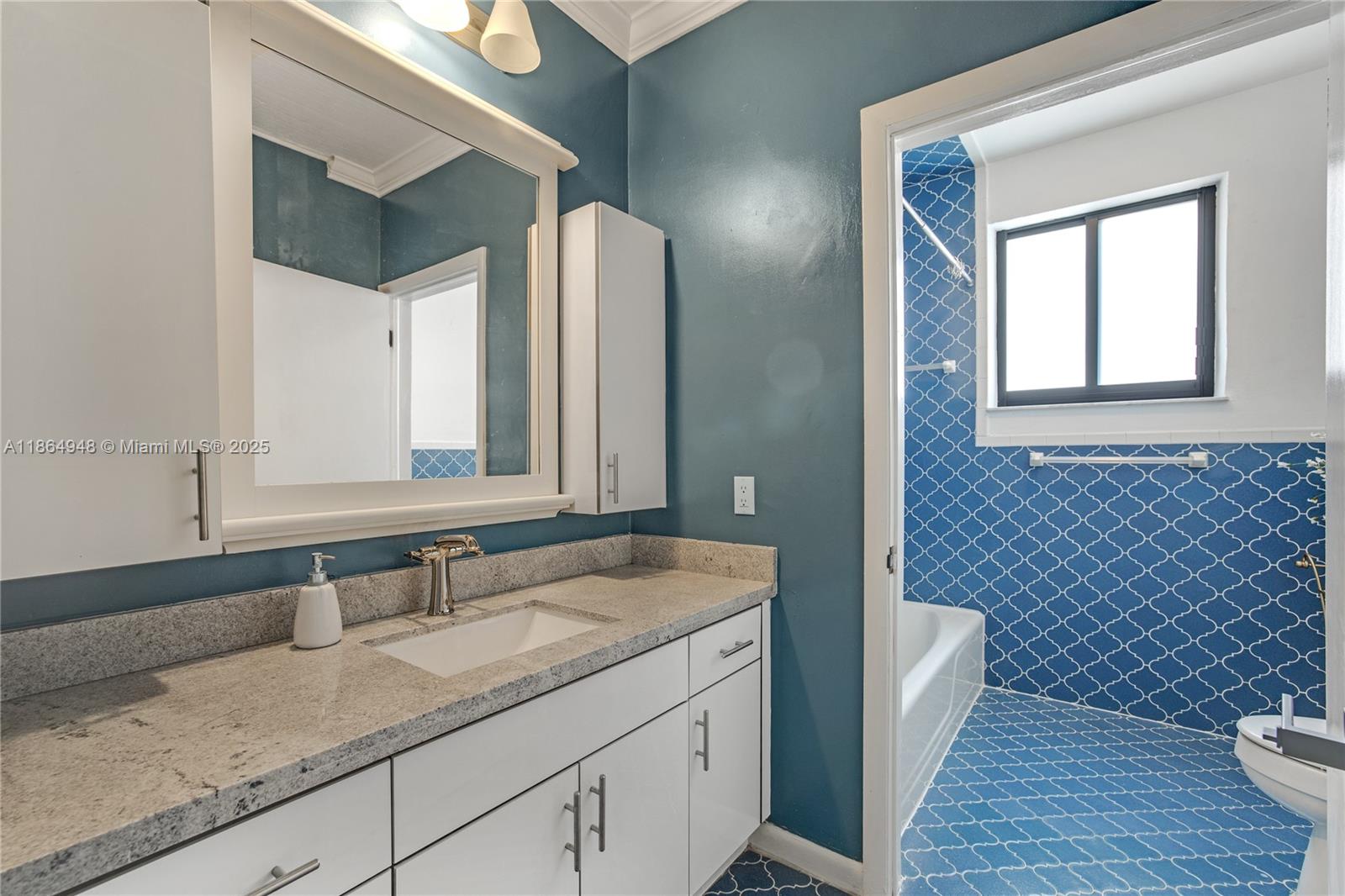 2022 Southwest 82nd Court, Unit B Miami, FL 33155 - Photo 6 of 15 a bathroom with a granite countertop sink and a mirror