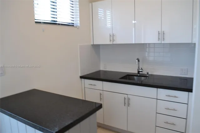 a kitchen with a sink and cabinets