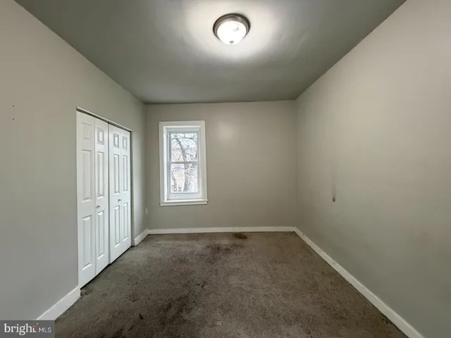 an empty room with a empty space and windows