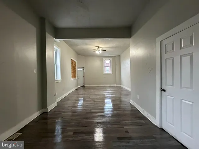a view of a hallway with wooden floor