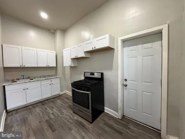 a kitchen with granite countertop cabinets and steel stainless steel appliances
